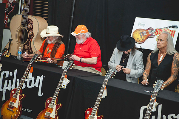 Dickey Betts, Charlie Daniels, Gary Rossington and Rickey Medlocke signing 50 guitars