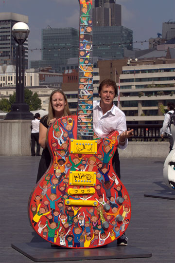 Sir Paul McCartney Visits Gibson Guitartown London to Sign His 10-foot Gibson Les Paul