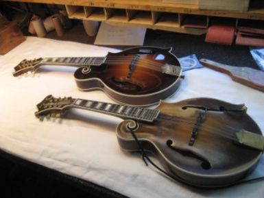 Gibson Sam Bush Signature mandolin next to the original Ole Hoss