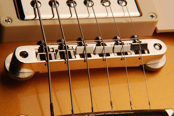 The Bridge: A bridge that needs to be adjusted too low or too high may be an indication of a neck that needs resetting. An improperly set neck can cause the entire guitar to play out of tune. The bridge or saddles should be intonated with a properly calibrated strobe or electronic tuner.